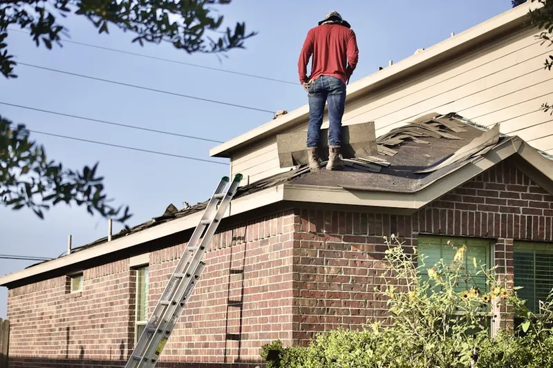 Professional roofer working on a residential roof in Calvert Hills Historic District